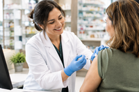 Pharmacist administering a flu shot at Westmont Pharmacy as part of a winter wellness checklist